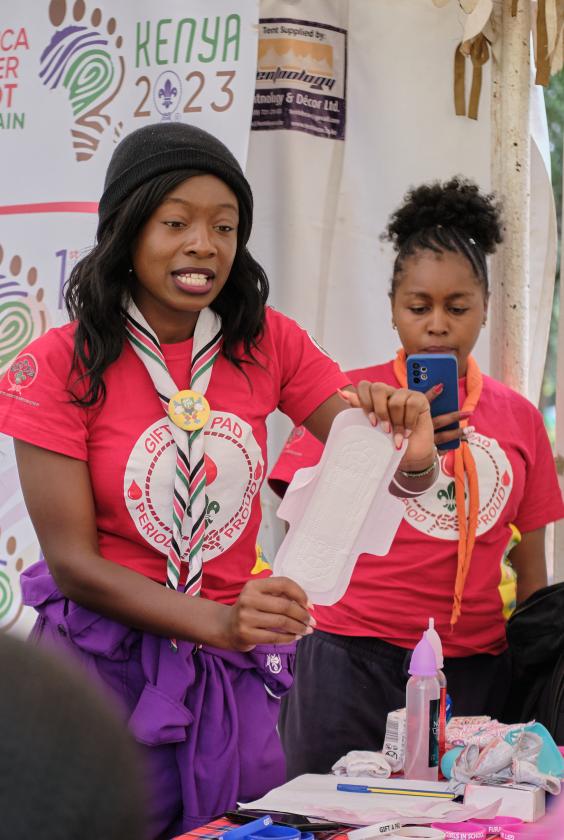 A scout leader holding a sanitary pad