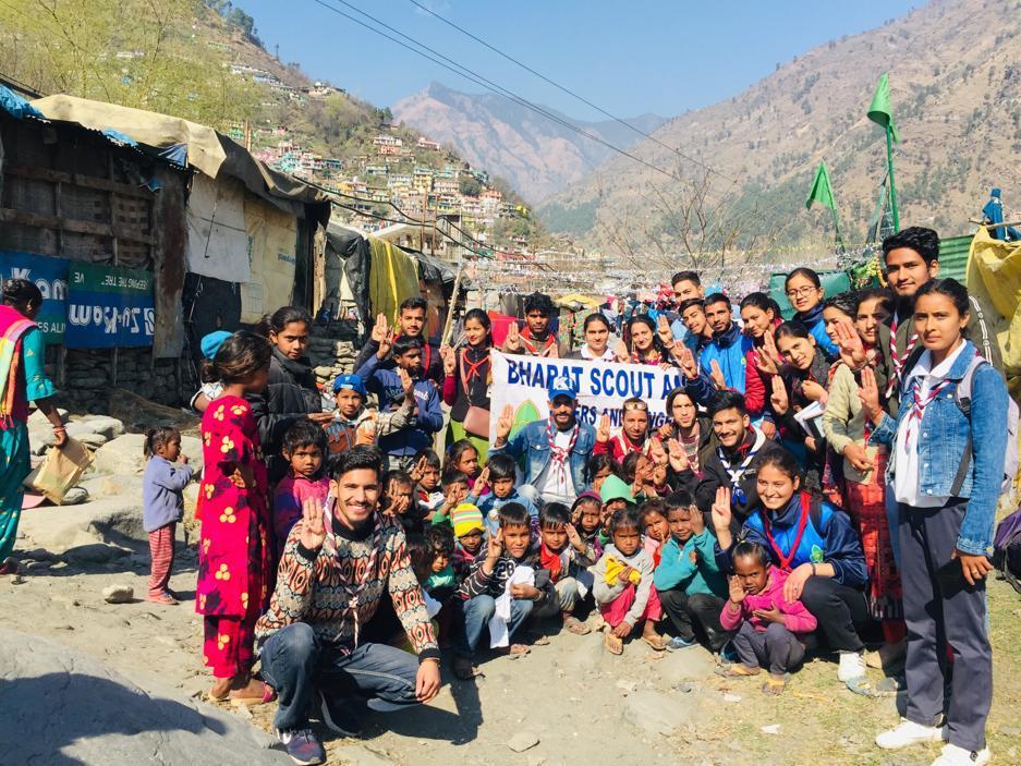 celebrating birthday of Robert Baden Powell and distributing cloths to slum pepole