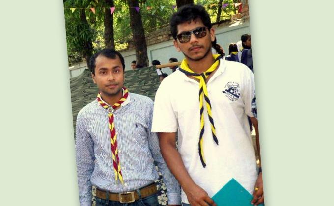 TWO BANGLADESHI SCOUTS BLOW OUT THE FIRE OF A B.R.T.C. BUS 