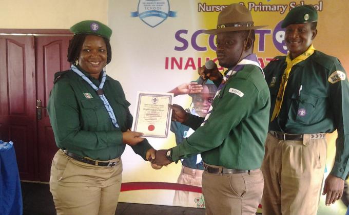 INVESTITURE OF LESS PRIVILEGE CUBS AND SCOUT BY PASTOR CHRIS OYAKILOME AS HE DONATES 50 CUBS AND SCOUT