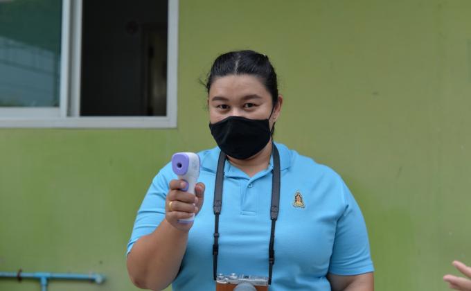 ปฏิบัติหน้าที่ตรวจวัดไข้นักเรียน