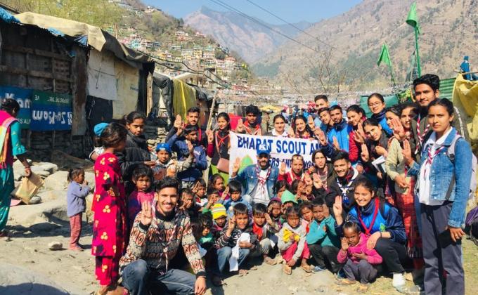 celebrating birthday of Robert Baden Powell and distributing cloths to slum pepole